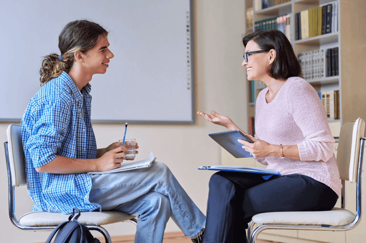 Behaviour Support Practitioner talking to an individual in an high school setting